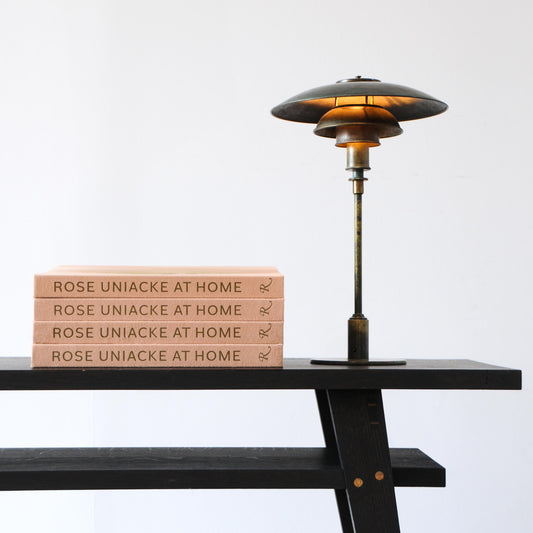 A sleek dark bronze poul henningsen ph 5 lamp with tiered disc shade and warm amber glow in rose uniacke at home