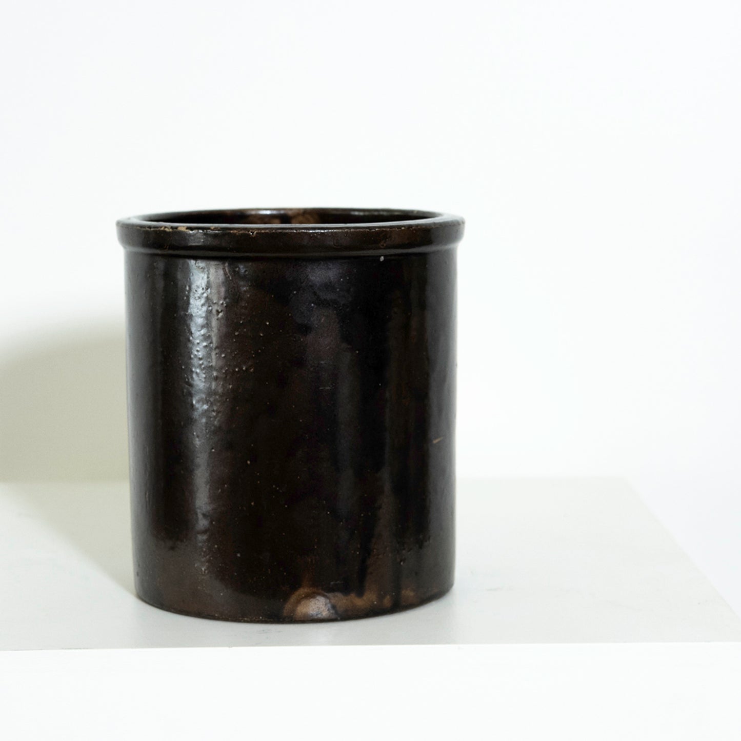Black cylindrical container on a white background