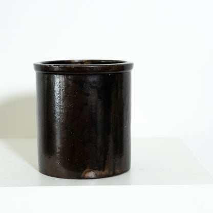 Black cylindrical container on a white background