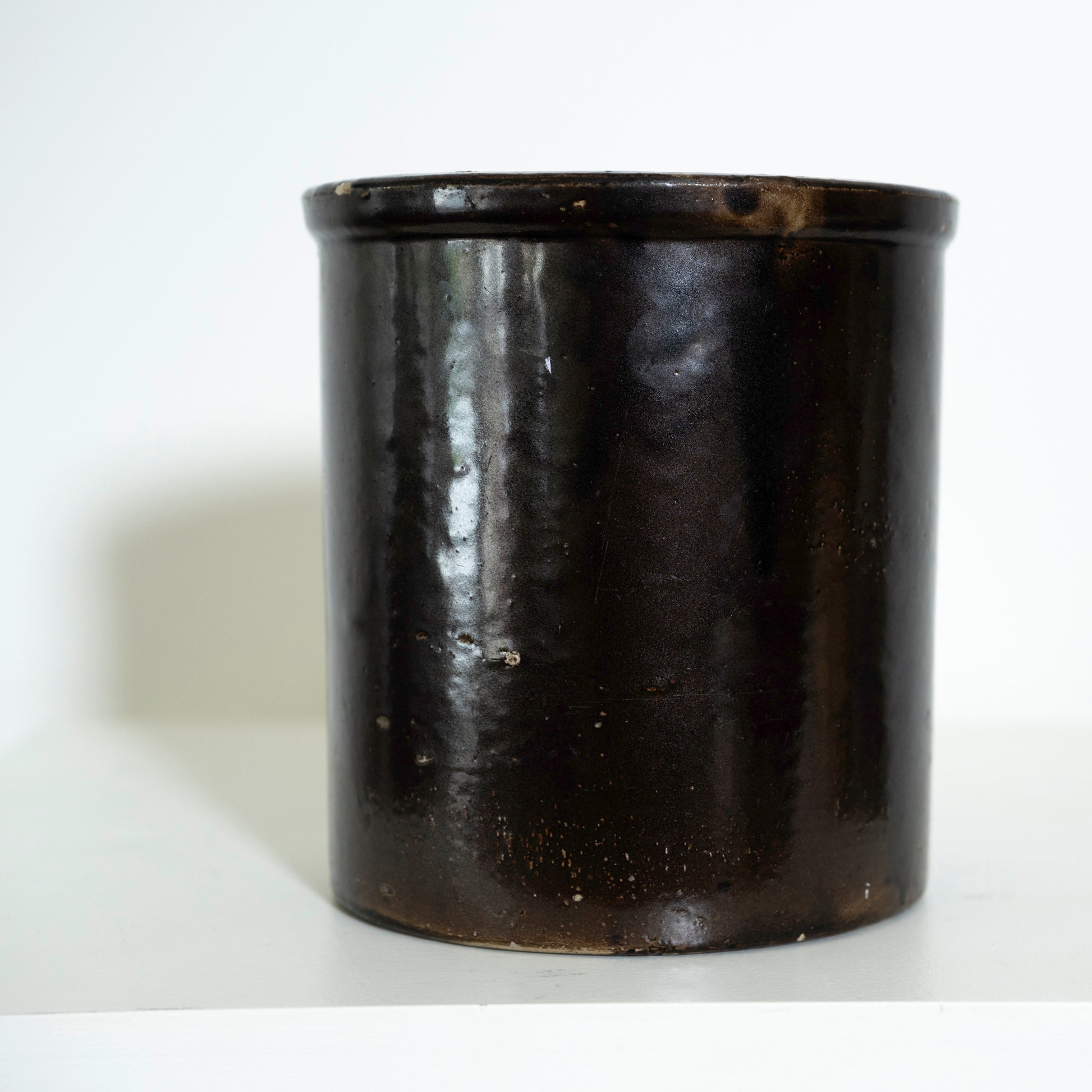 Black ceramic jar on a white background