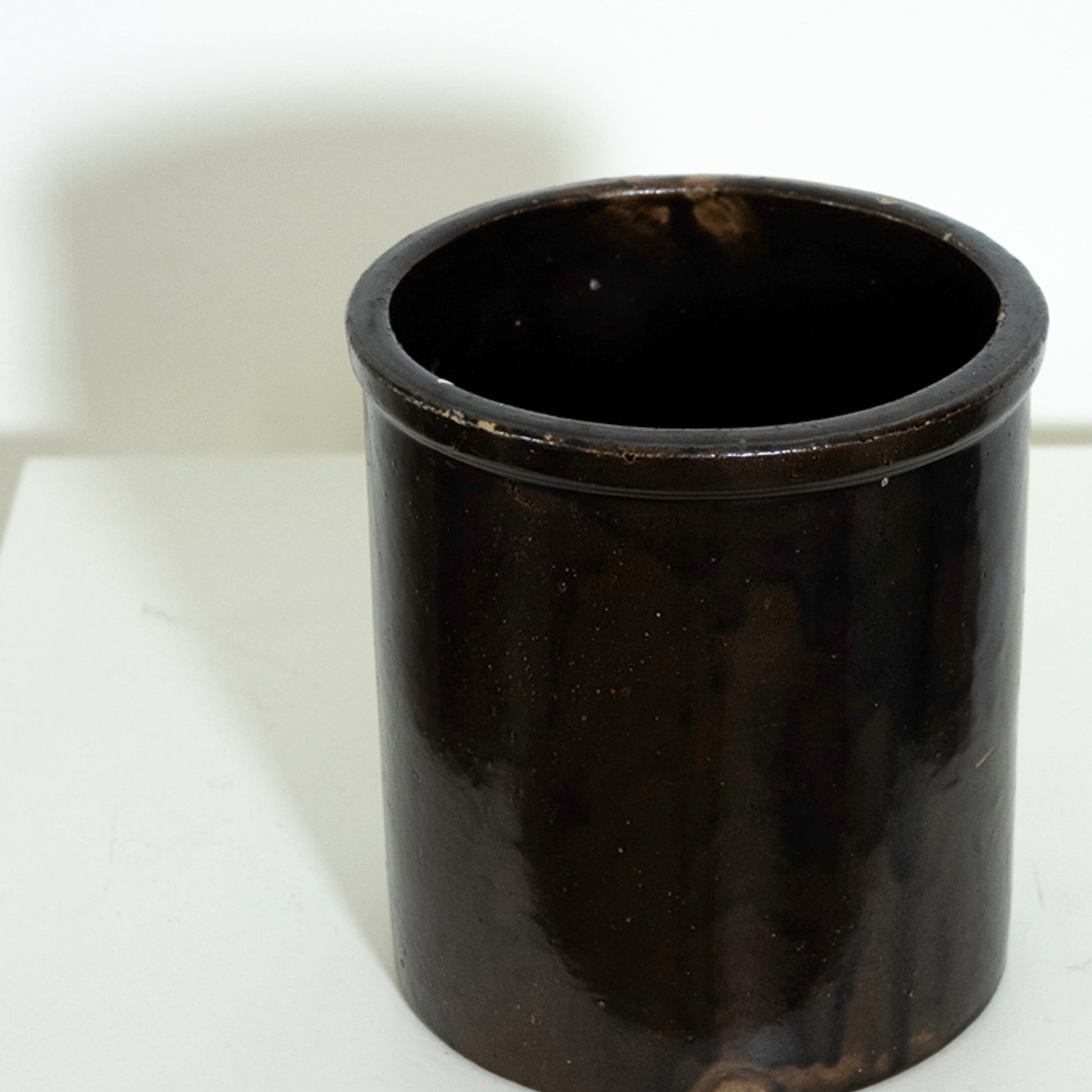 Black cylindrical container on a white background