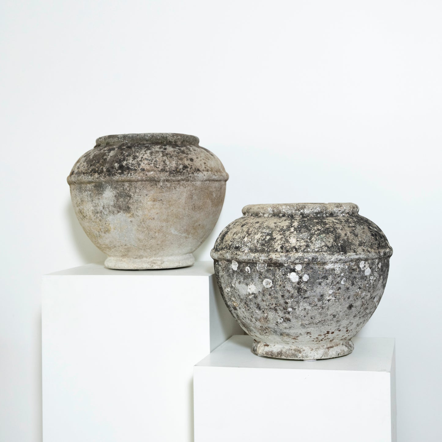 Two rustic stone pots on a white background