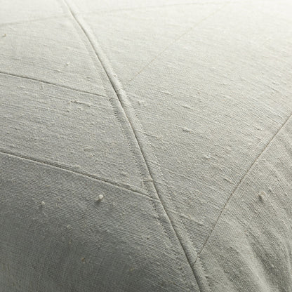 Light gray quilted fabric with stitching on vintage canvas panelled pillow showcasing textured weave detail