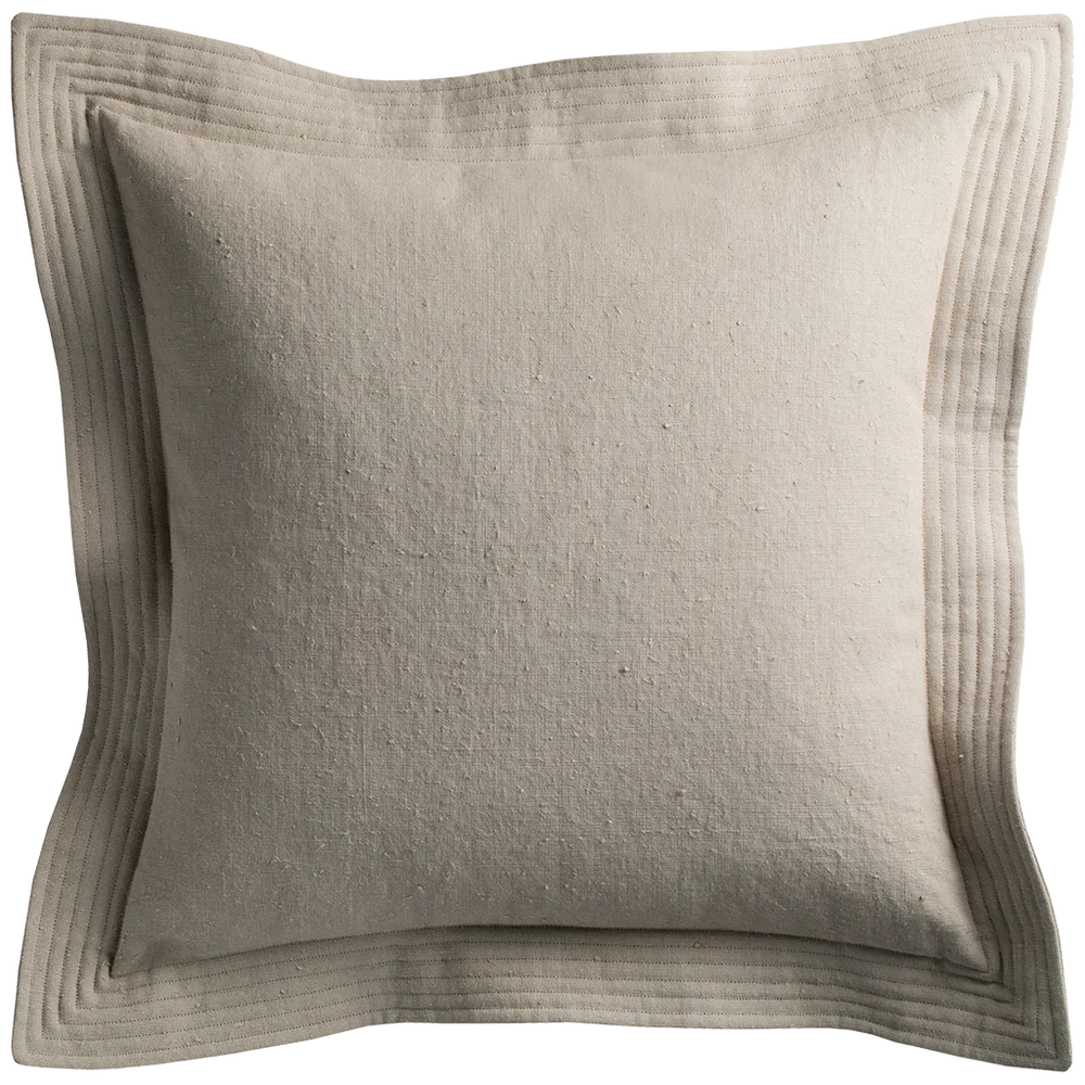 Beige linen quilted edge pillow with subtle texture and stitched layered border detailing in cement color