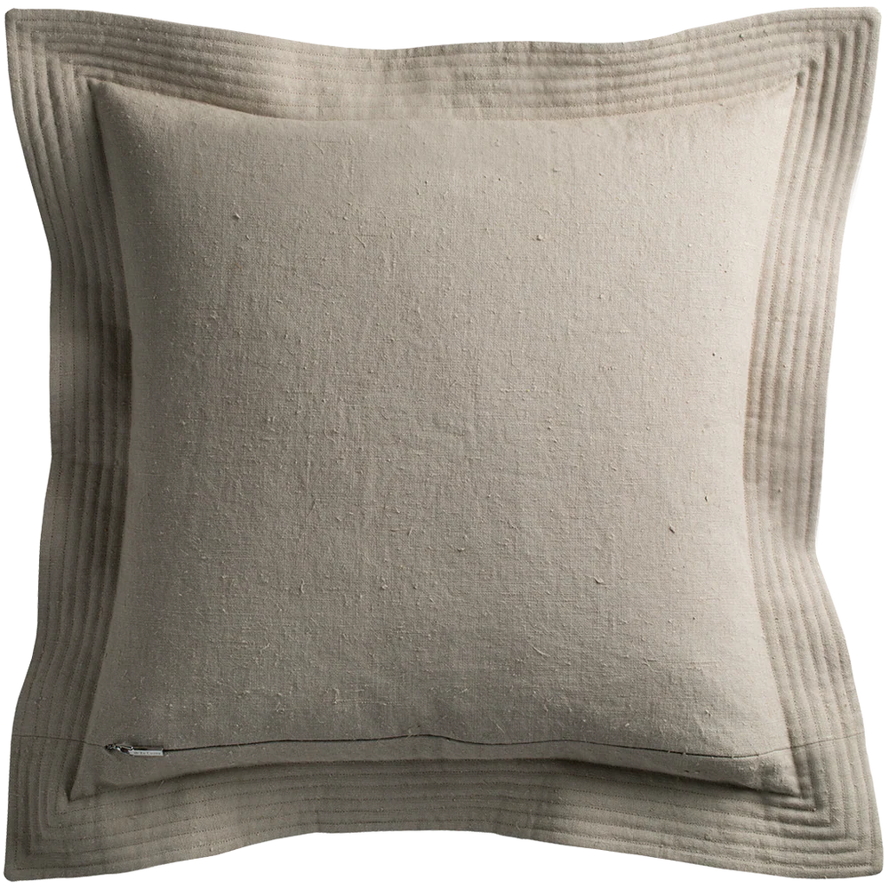 Beige linen quilted edge pillow with subtle texture and stitched border detailing in cement color