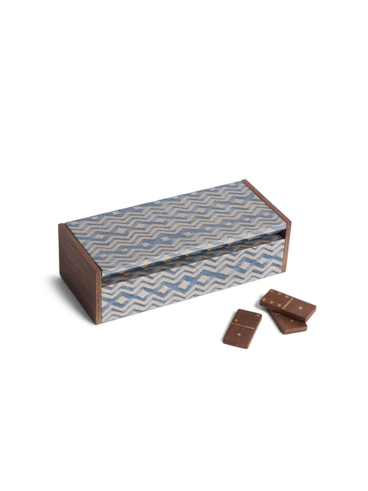 Fortuny dominoes set in a rectangular wooden box with dark brown sides and a blue and white zigzag patterned lid