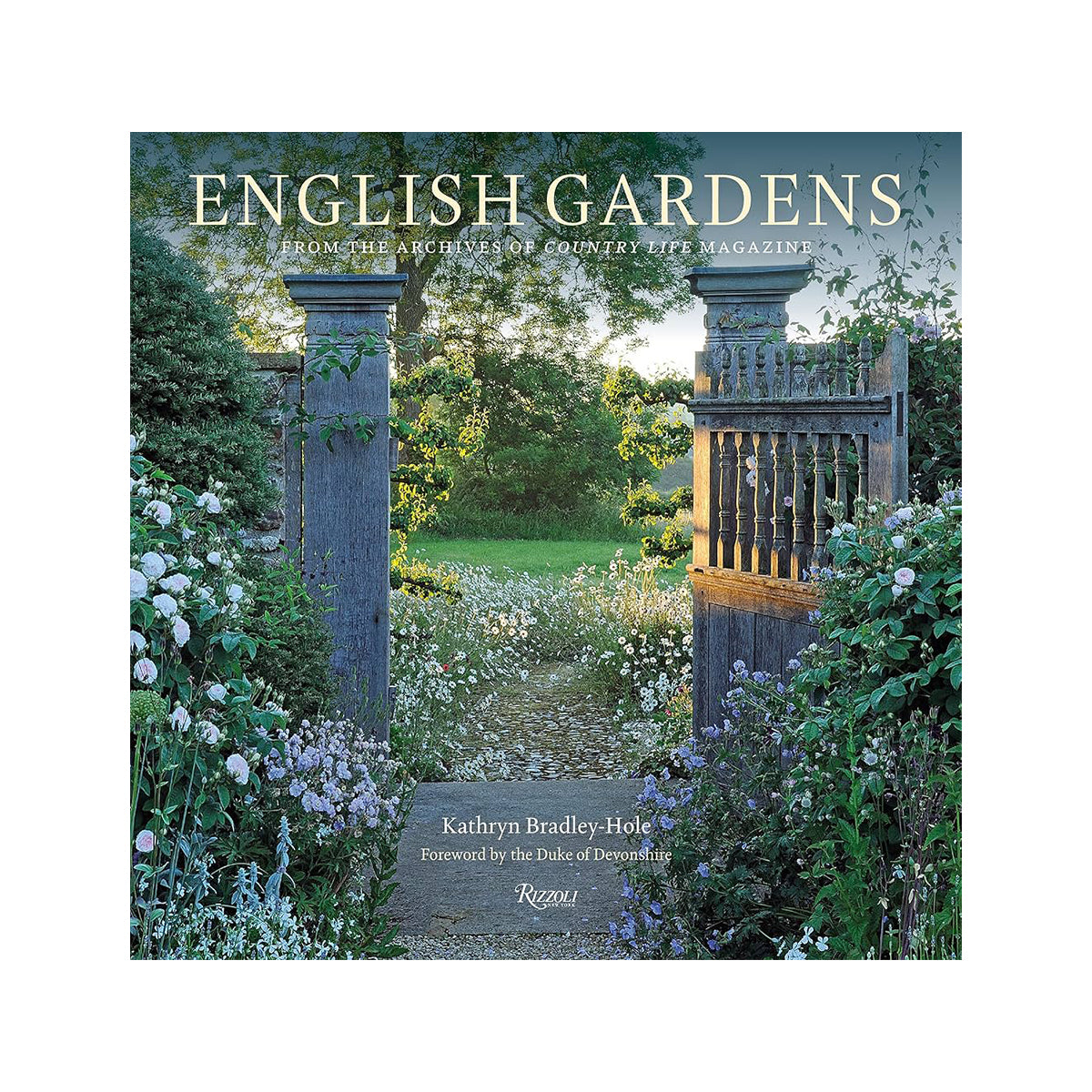 A weathered wooden garden gate with ornate carvings flanked by lush greenery and white flowers in english gardens