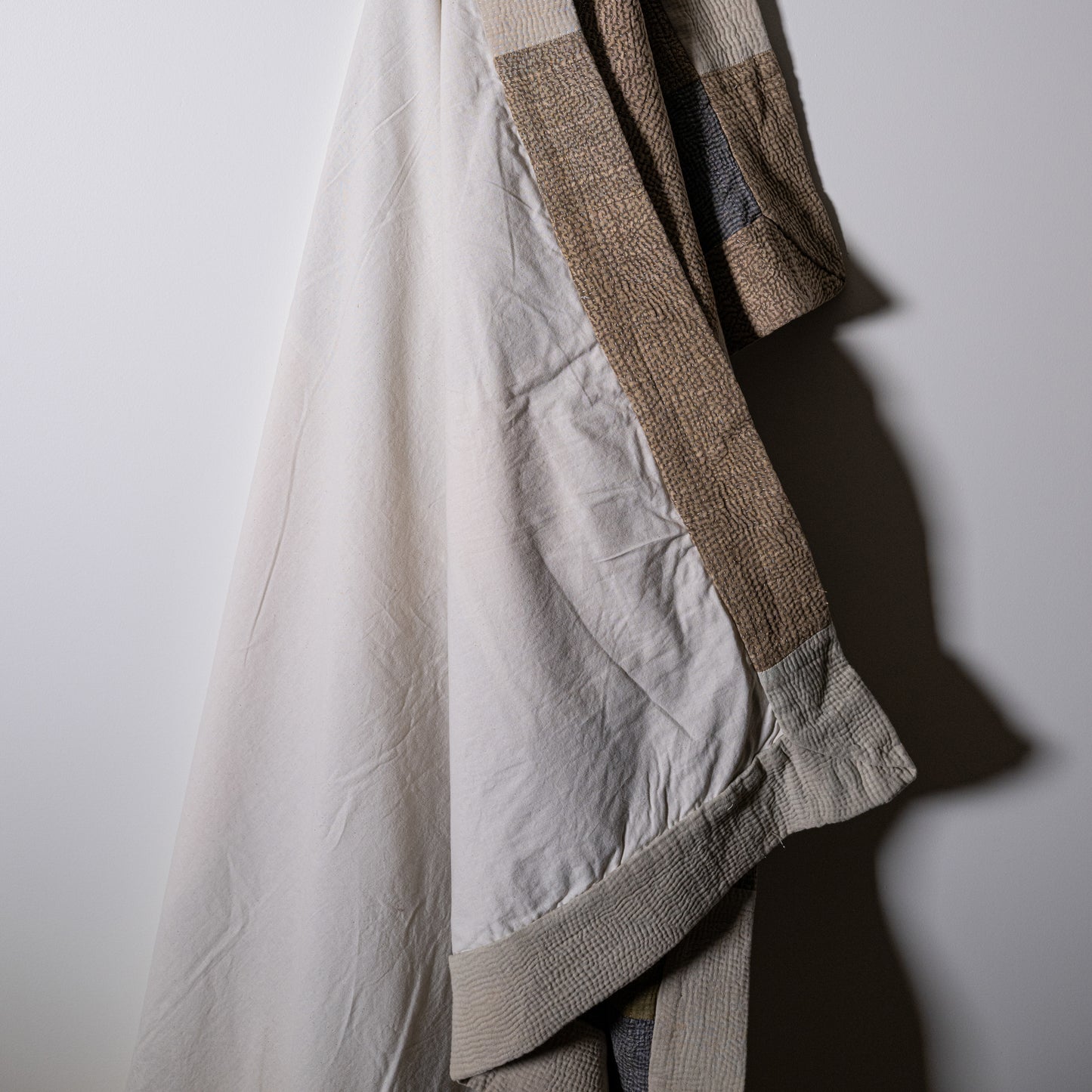 Mosaic Quilt textured patchwork jacket in beige and cream woven fabric with a cozy quilted design