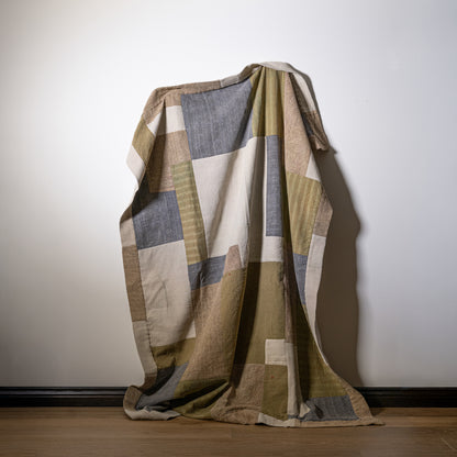 Mosaic quilt patchwork blanket with geometric pattern in earthy beige olive green and muted gray tones