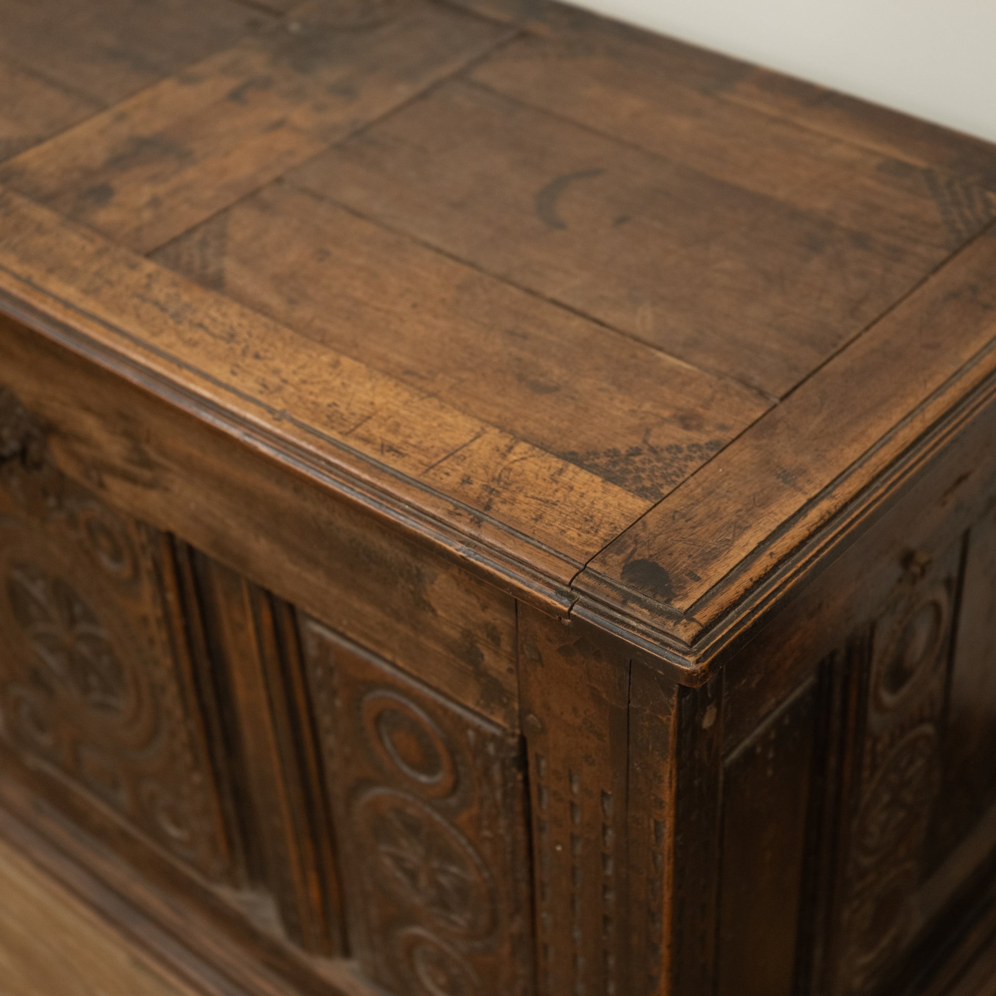 Antique dark brown wooden 19th century French mountain chest with carved floral and circular patterns on its sides