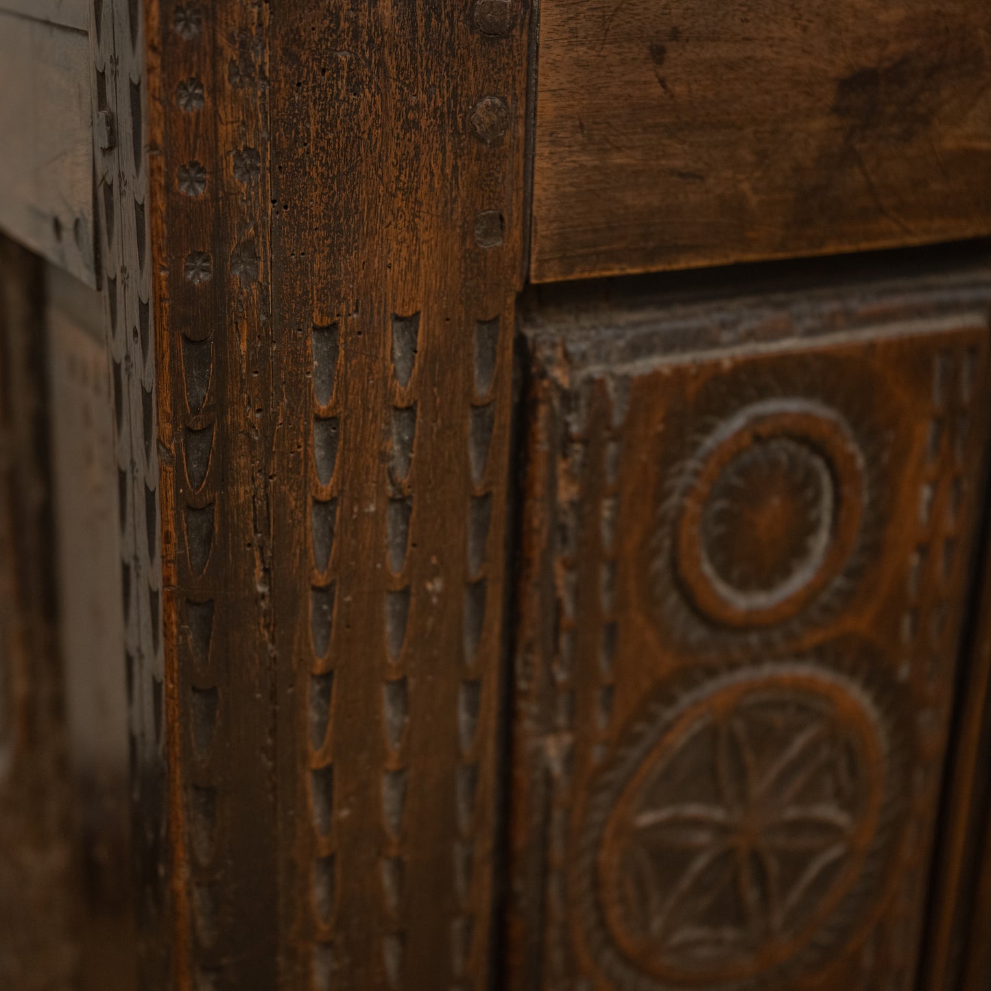Antique 19th century French carved wooden mountain chest with intricate carvings and weathered dark brown finish