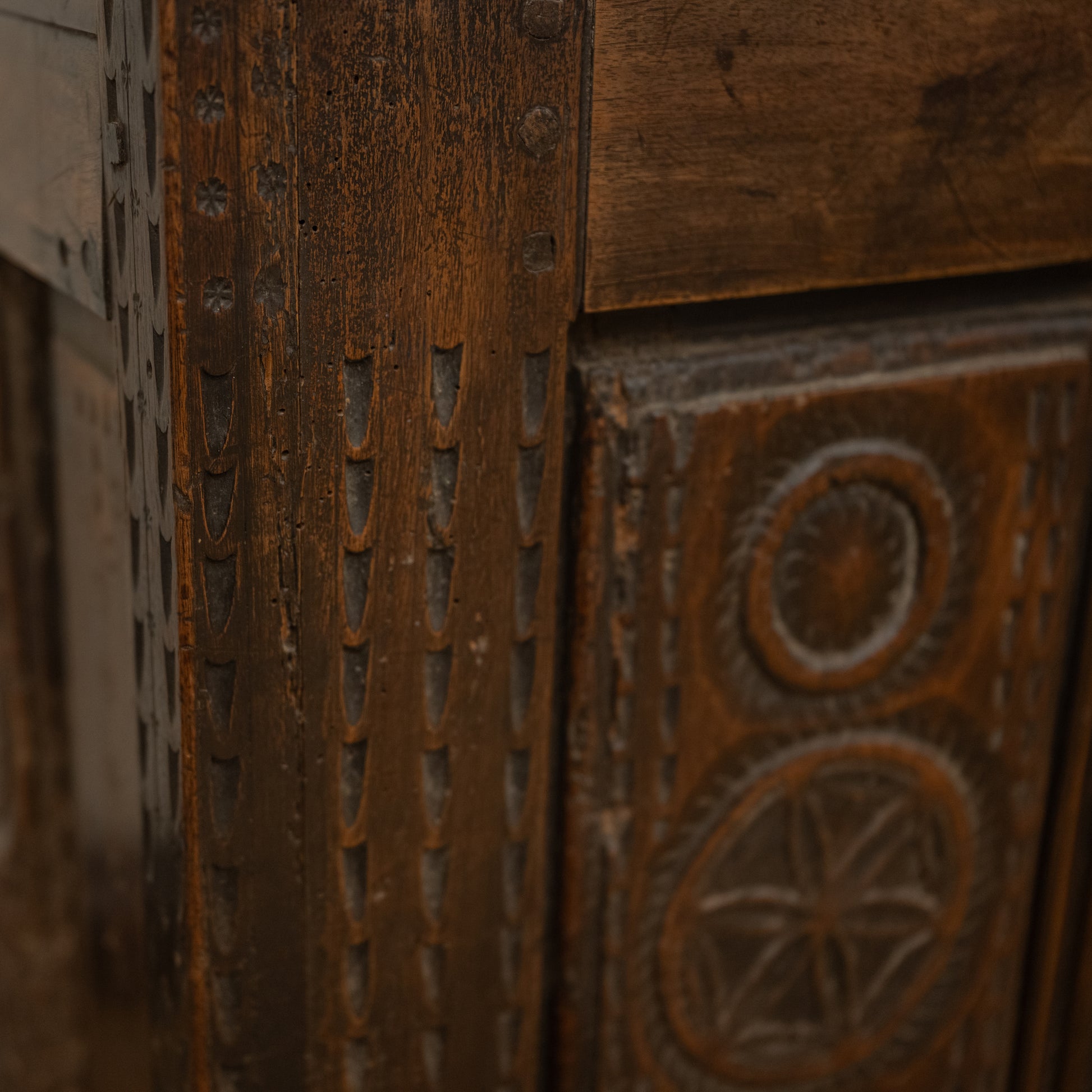 Antique 19th century French carved wooden mountain chest with intricate carvings and weathered dark brown finish