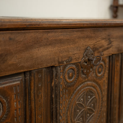 Antique 19th century French carved mountain chest in dark brown wood with intricate detailed carvings